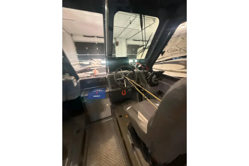 Slide: The Image of Interior view of 2022 Hewescraft 270 Alaskan Hardtop boat, showcasing steering and seating area. - 13