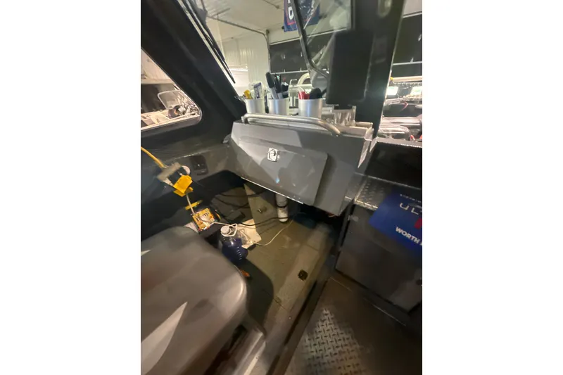 Slide: The Image of Interior view of 2022 Hewescraft 270 Alaskan Hardtop boat cabin with storage and equipment. - 16