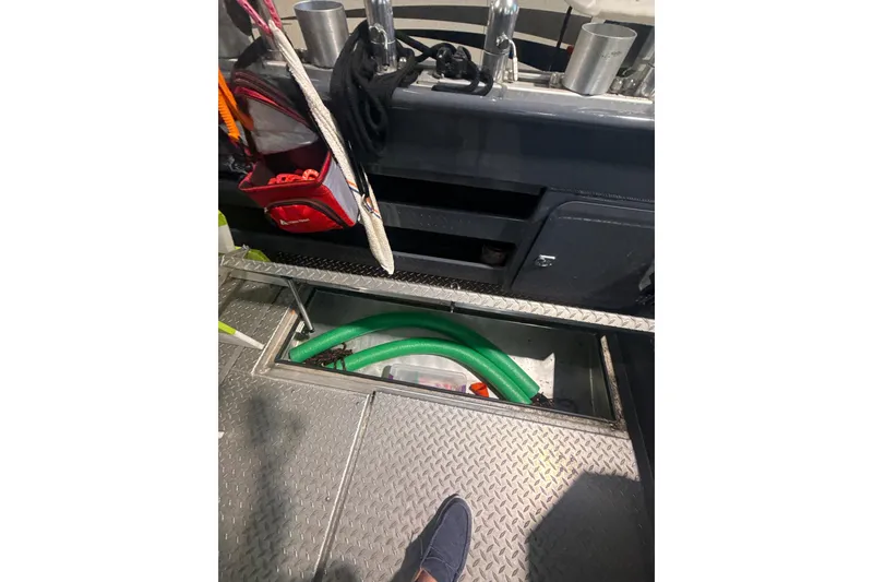 Slide: The Image of Interior view of 2022 Hewescraft 270 Alaskan Hardtop boat with storage compartment open. - 20