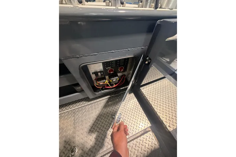 Slide: The Image of 2022 Hewescraft 270 Alaskan Hardtop electrical panel with open access door. - 21