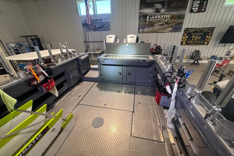 Slide: The Image of 2022 Hewescraft 270 Alaskan Hardtop interior with fishing rod holders and storage compartments. - 22