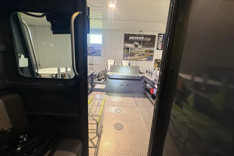 Slide: The Image of Interior view of 2022 Hewescraft 270 Alaskan Hardtop in a workshop setting. - 26