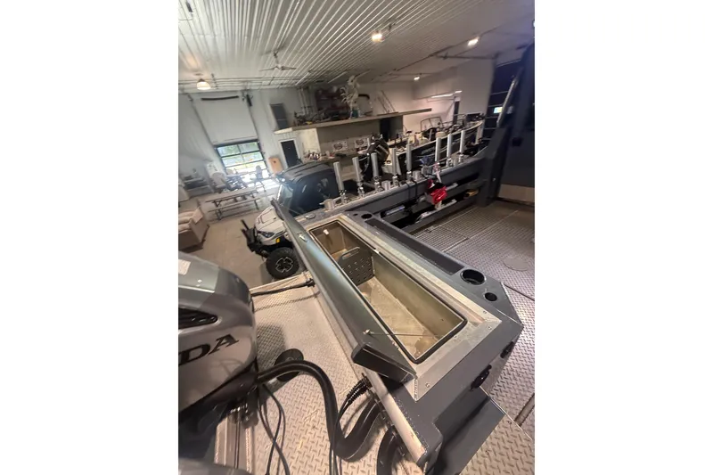 Slide: The Image of 2022 Hewescraft 270 Alaskan Hardtop in a workshop, showcasing interior and equipment. - 32