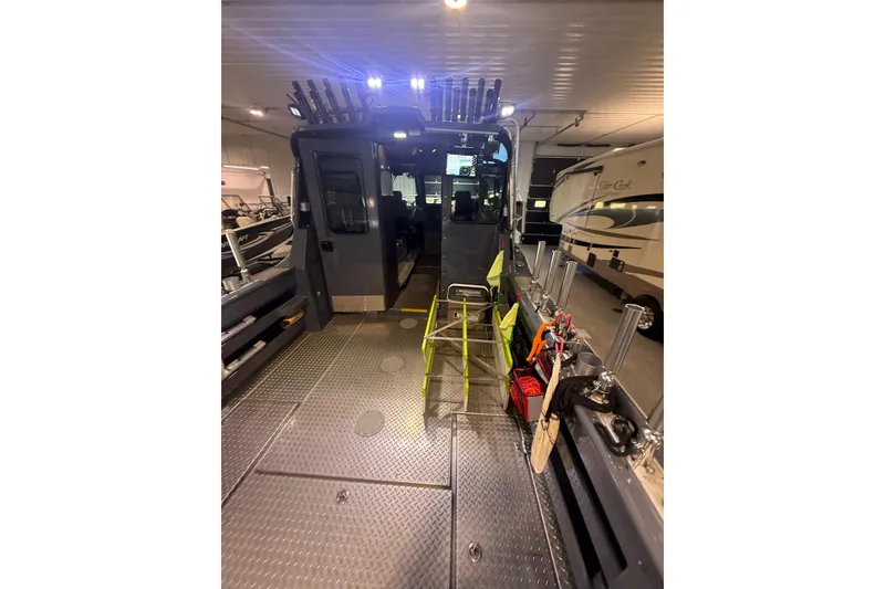 Slide: The Image of 2022 Hewescraft 270 Alaskan Hardtop interior with fishing gear and equipment in a garage. - 34