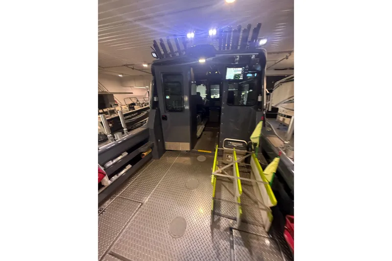 Slide: The Image of 2022 Hewescraft 270 Alaskan Hardtop interior with fishing rod holders and equipment. - 35