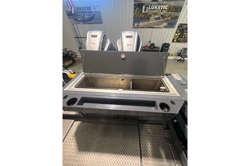 Slide: The Image of 2022 Hewescraft 270 Alaskan Hardtop boat interior with open storage compartment. - 6