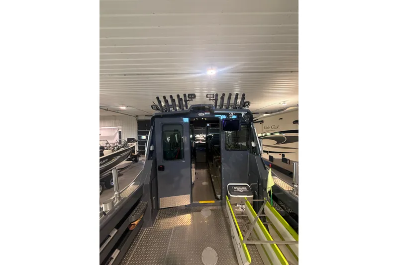 Slide: The Image of 2022 Hewescraft 270 Alaskan Hardtop boat in indoor showroom, rear view. - 8