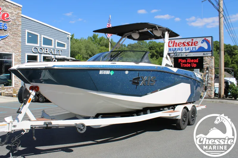 The Image of 2025 Axis A245 on a trailer in front of a boat sales shop. - 1