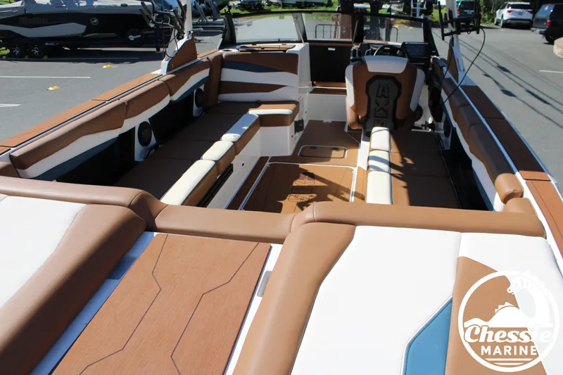Slide: The Image of Interior view of an Axis A245 boat with brown and white seating. - 12