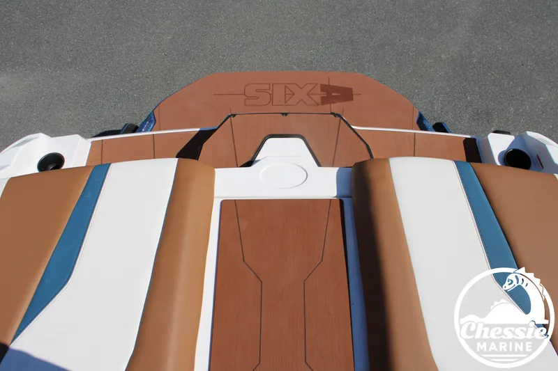 Slide: The Image of Rear view of an Axis A245 boat with brown and white upholstery on a trailer. - 13
