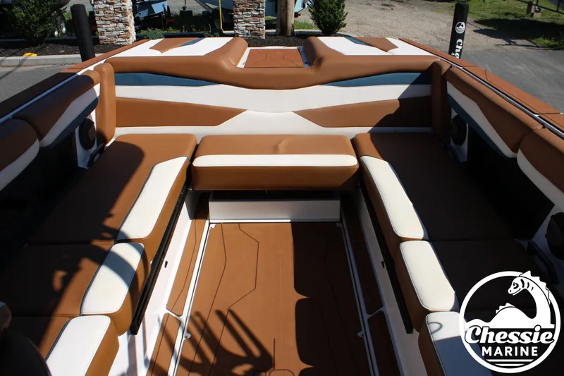 Slide: The Image of Interior view of a 2025 Axis A245 boat with brown and white seating. - 14