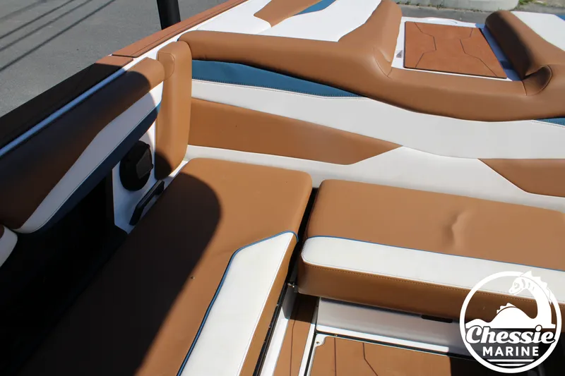Slide: The Image of Interior of a 2025 Axis A245 boat with brown and white seating, Chessie Marine logo visible. - 18