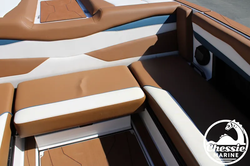 Slide: The Image of Interior of a 2025 Axis A245 boat with brown and white seating. - 19