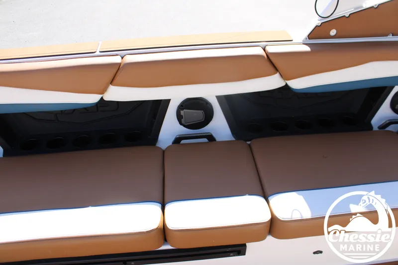 Slide: The Image of Rear seating of an Axis A245 boat with brown upholstery and speakers. - 21