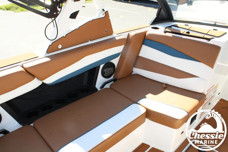 Slide: The Image of Interior view of a 2025 Axis A245 boat with brown and white seating. - 22