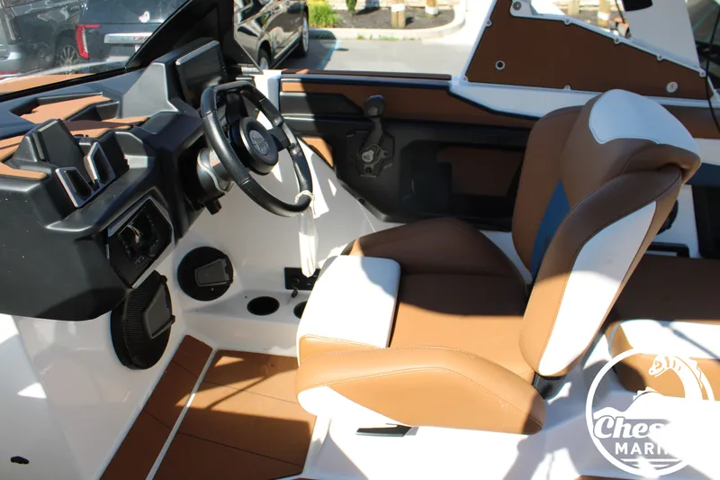 Slide: The Image of Interior of a 2025 Axis A245 boat with brown and white seating. - 23