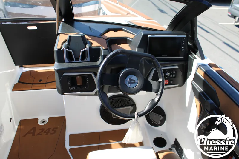 Slide: The Image of Interior view of a 2025 Axis A245 boat with modern helm and electronics. - 24