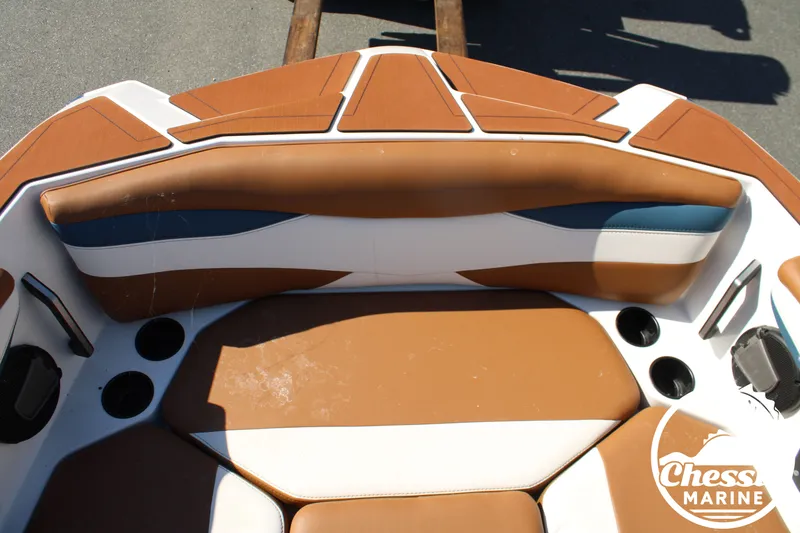 Slide: The Image of The image shows the bow area of an Axis A245 boat with brown and white upholstery. - 27