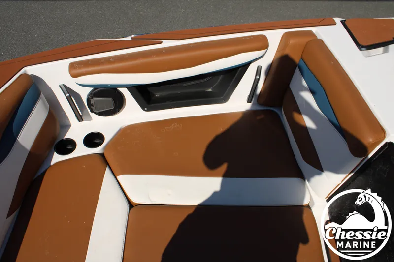 Slide: The Image of Interior view of a 2025 Axis A245 boat with brown and white upholstery. - 28