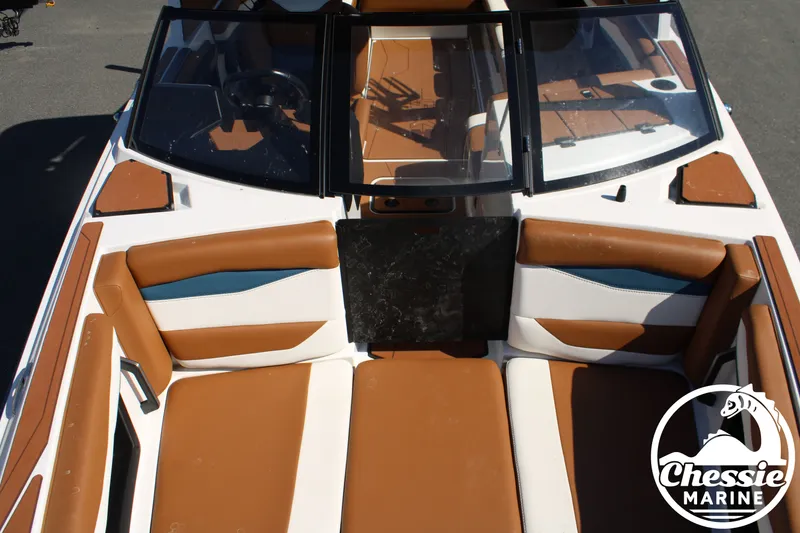 Slide: The Image of The image shows the cockpit of a 2025 Axis A245 boat with brown seating. - 30