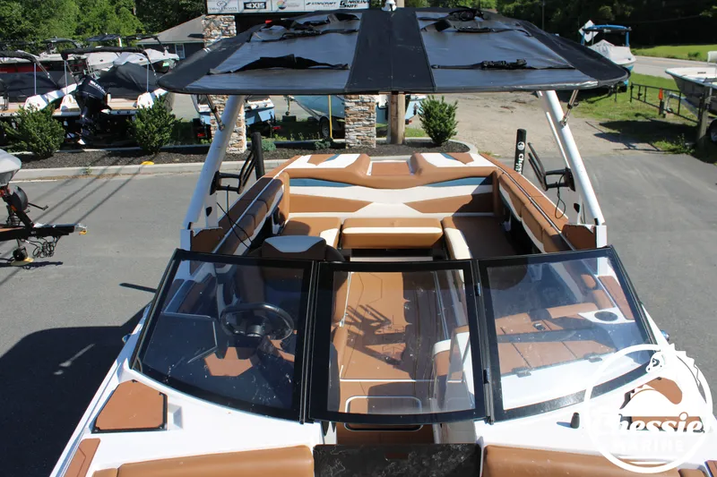 Slide: The Image of The image shows a 2025 Axis A245 boat with brown seating and a black sunshade. - 31