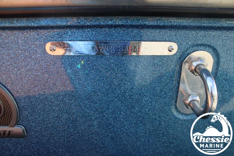 Slide: The Image of Close-up of a boat hull with a silver nameplate and a metal handle. - 32