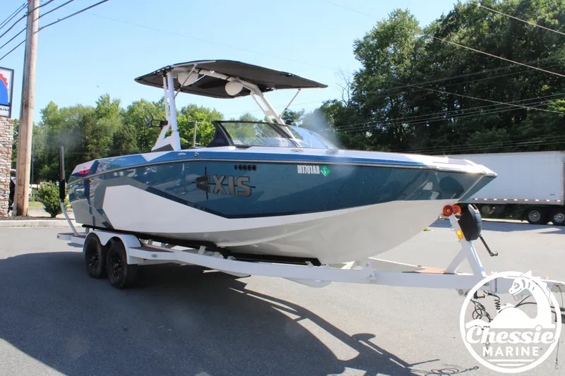 Slide: The Image of A 2025 Axis A245 boat on a trailer in a parking lot. - 7
