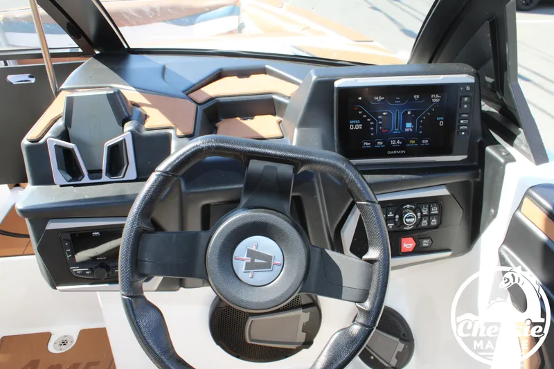 Slide: The Image of Dashboard of an Axis A245 boat with steering wheel and Garmin display. - 9