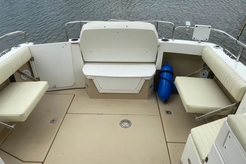 Slide: The Image of 2013 Cutwater 28 boat deck with beige seating and blue fender. - 12