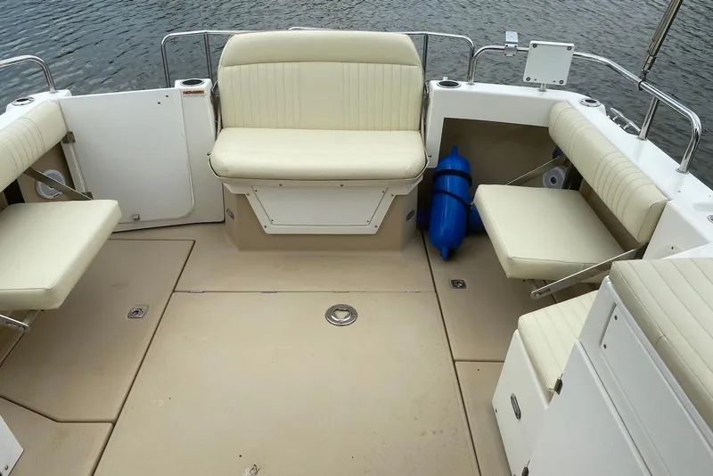 Slide: The Image of 2013 Cutwater 28 boat interior with beige seating and water view. - 13