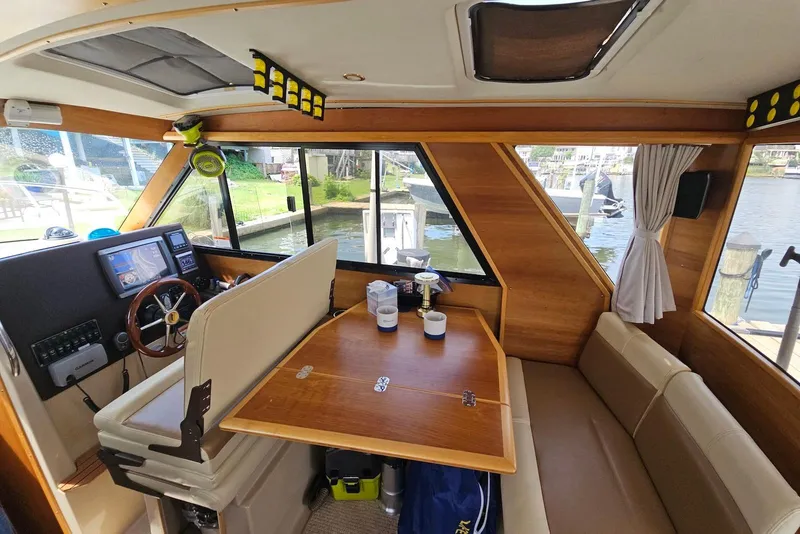 Slide: The Image of Interior of a 2013 Cutwater 28 boat with wooden accents and navigation equipment. - 16
