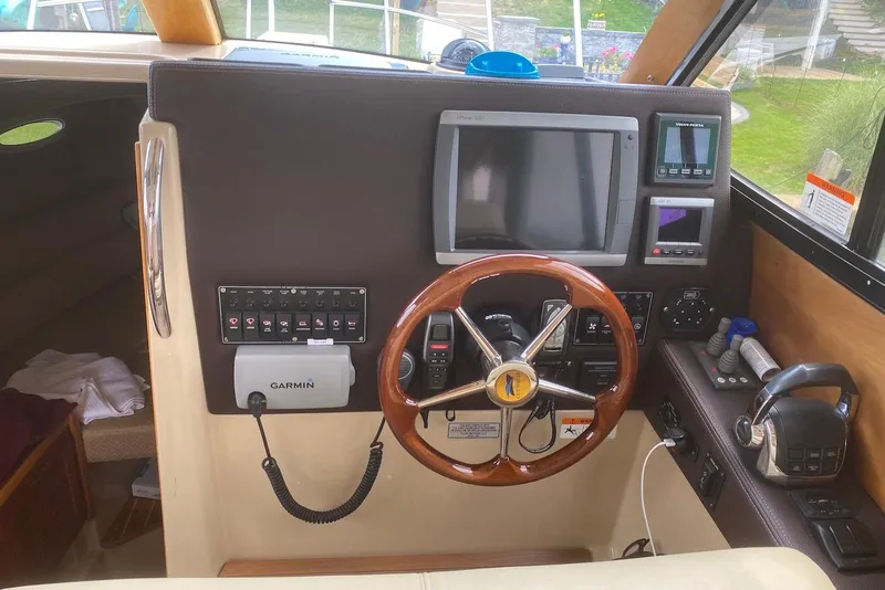 Slide: The Image of Helm of 2013 Cutwater 28 boat with Garmin navigation and wooden steering wheel. - 19