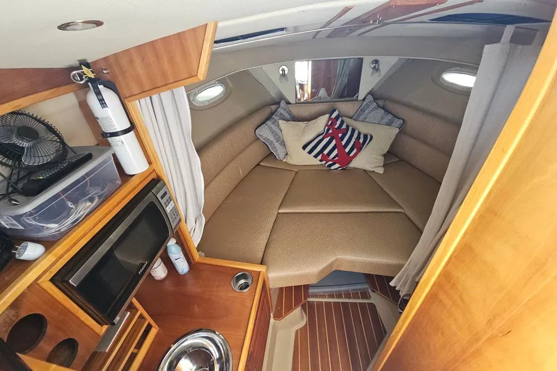 Slide: The Image of Interior of a 2013 Cutwater 28 boat with cozy cabin and kitchenette. - 22