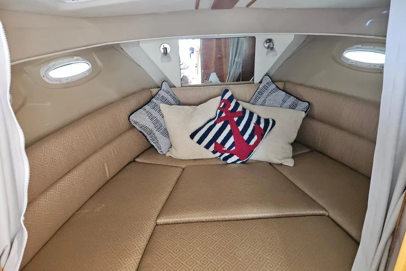 Slide: The Image of Cozy cabin interior of a 2013 Cutwater 28 boat with nautical-themed pillows. - 25