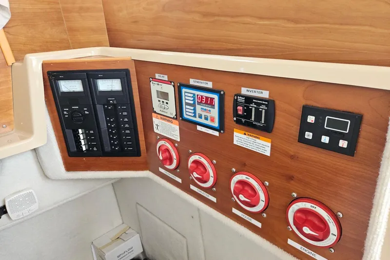 Slide: The Image of Control panel of a 2013 Cutwater 28 boat with switches and meters. - 28