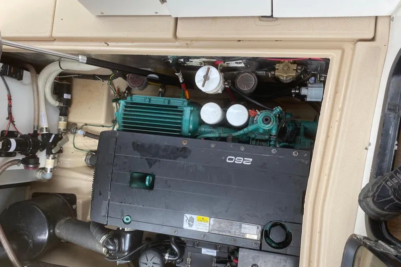 Slide: The Image of Engine compartment of a 2013 Cutwater 28 boat, showcasing mechanical components and wiring. - 31