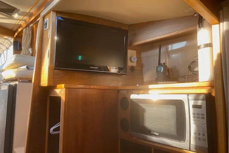 Slide: The Image of Interior of a 2013 Cutwater 28 boat with TV, microwave, and radio. - 23