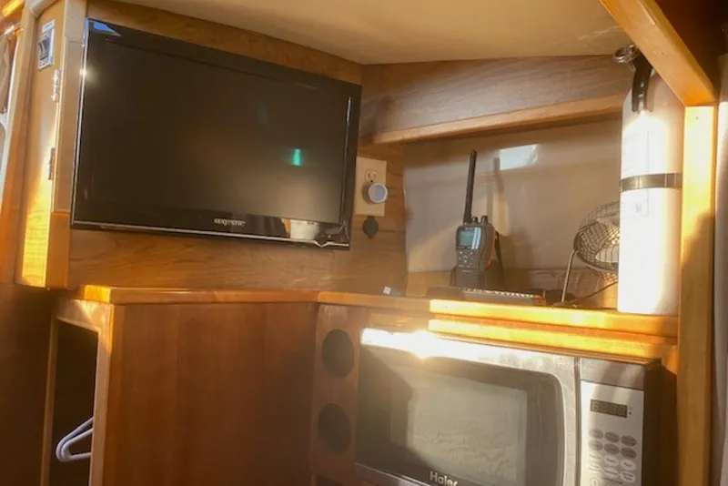 Slide: The Image of Interior of 2013 Cutwater 28 boat with TV, microwave, and radio equipment. - 24
