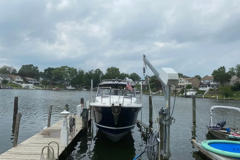 Slide: The Image of 2013 Cutwater 28 boat docked at a scenic lakeside marina. - 8