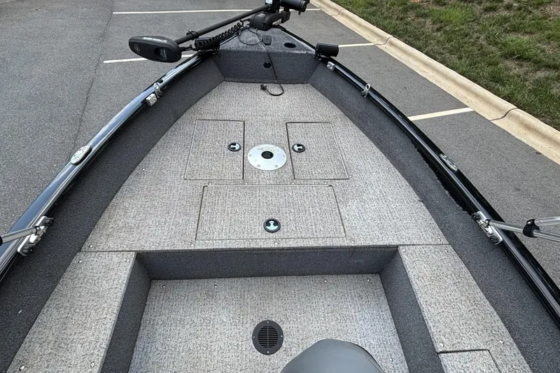 Slide: The Image of 2022 Tracker Super Guide V-16 T boat interior with carpeted deck and storage compartments. - 11