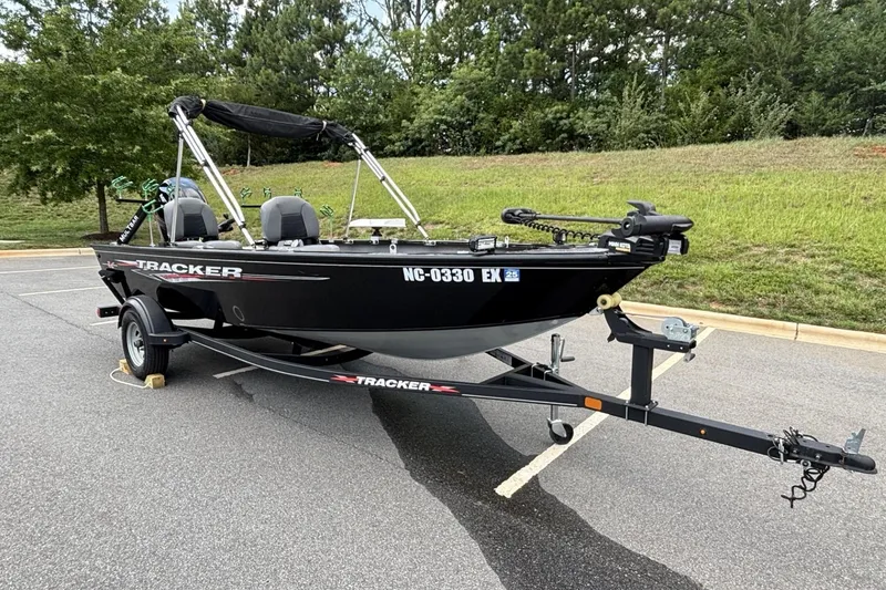 Slide: The Image of 2022 Tracker Super Guide V-16 T boat on trailer, parked outdoors. - 18