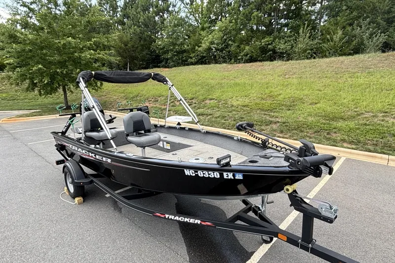Slide: The Image of 2022 Tracker Super Guide V-16 T fishing boat on trailer in parking lot. - 19