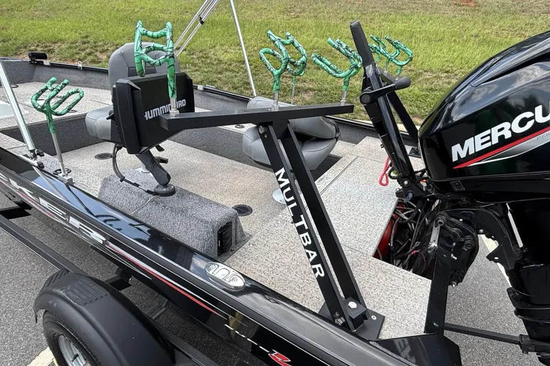 Slide: The Image of 2022 Tracker Super Guide V-16 T boat with fishing rod holders and Mercury engine. - 6