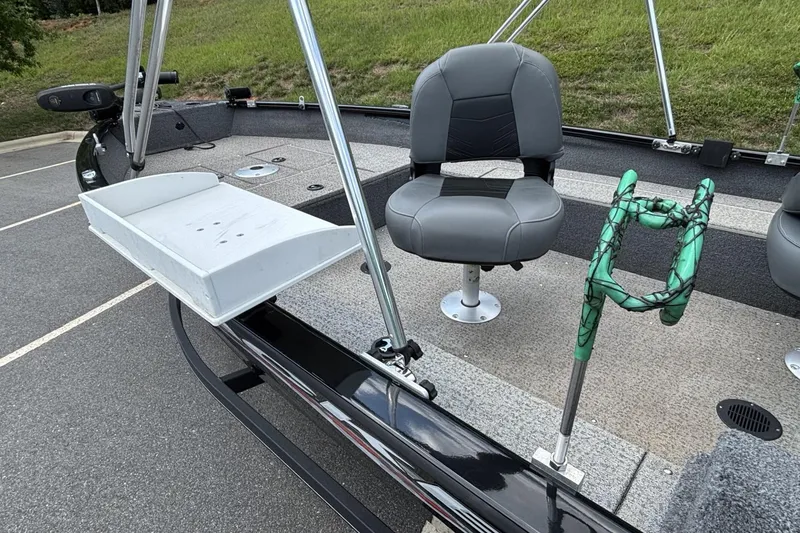 Slide: The Image of 2022 Tracker Super Guide V-16 T boat interior with seating and fishing rod holder. - 7