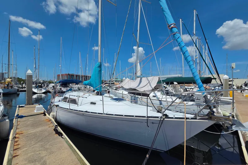 The Image of 1985 C&C 37 sailboat docked at marina under clear blue sky. - 1