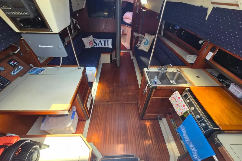 Slide: The Image of Interior of a 1985 C&C 37 sailboat with kitchen and seating area. - 4