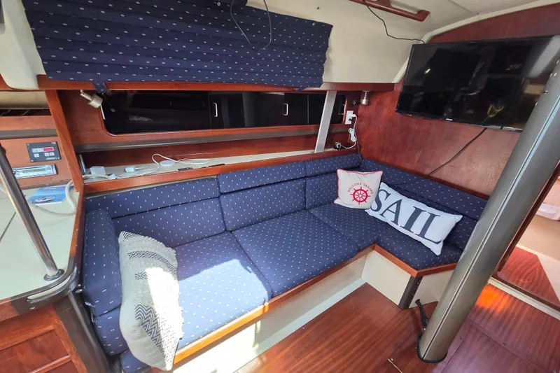Slide: The Image of Interior of 1985 C&C 37 sailboat with cozy seating and nautical decor. - 7