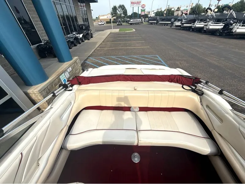 Slide: The Image of The image shows the cockpit of a 1996 Sea Ray 210 Signature with white seats and red accents. - 19