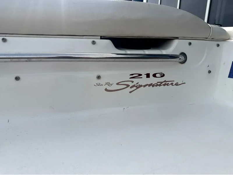 Slide: The Image of Close-up of the "Sea Ray 210 Signature" lettering on a white boat. - 5