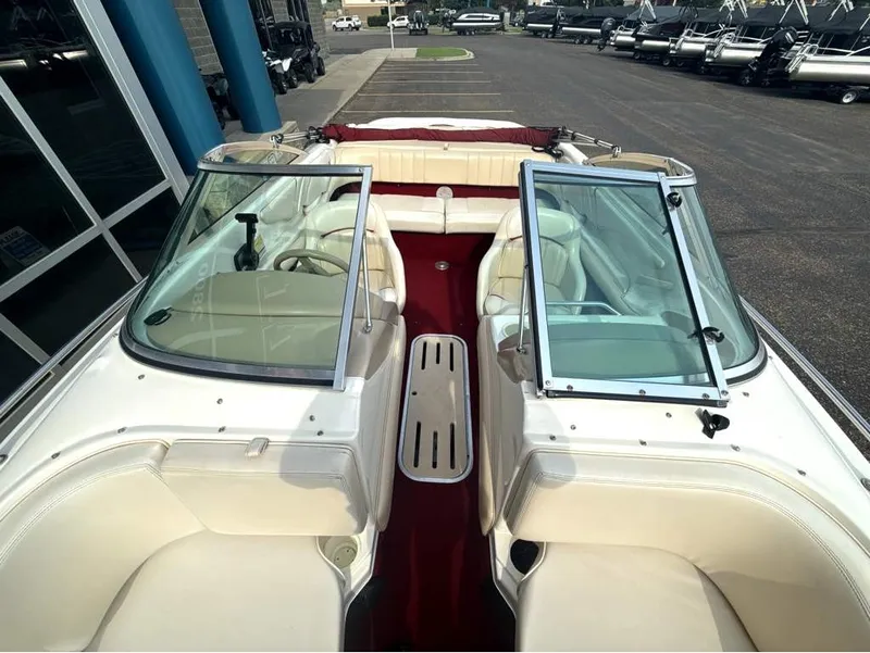 Slide: The Image of The image shows the cockpit of a 1996 Sea Ray 210 Signature boat with beige seating. - 17